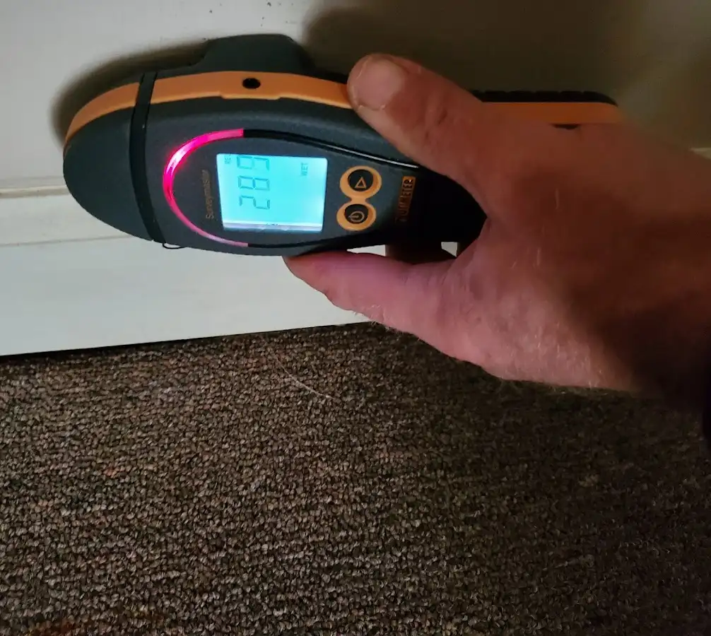 Moisture detection at baseboard during Storm Damage Restoration in Fortuna Foothills
